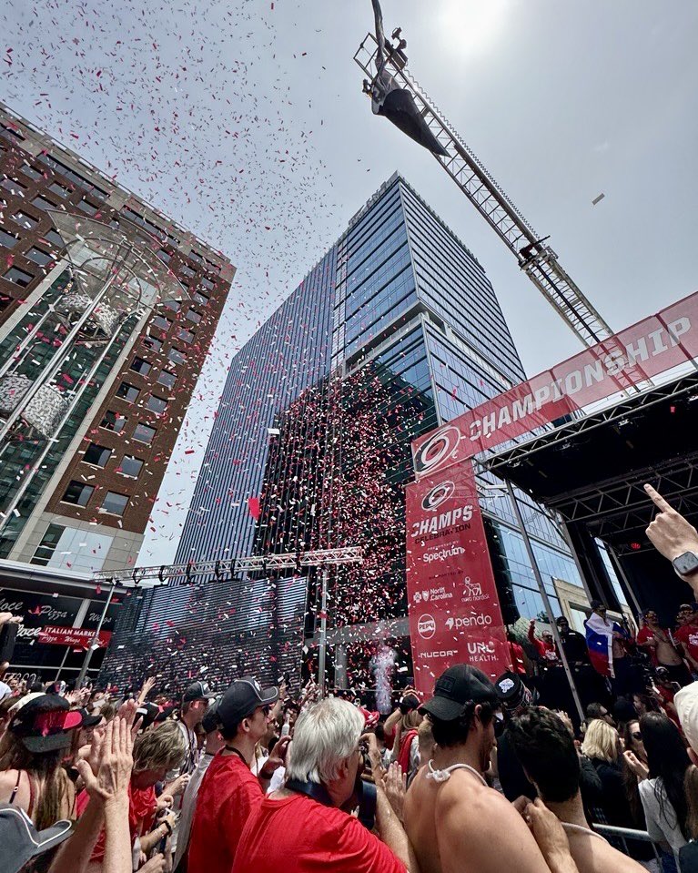 WakeGOV's tweet photo. Canes in six, the sirens sound,
Red and black flood all downtown.
Even David Ellis donned a cape for the day,
Wake County cheering, streets on display.
What brings 100,000 out today? π
#CanesInSix #TakeWarning #WakeCounty #StanleyCupParade #CanesCounty @Canes @RaleighGov @WakeCountyMgr ππ
