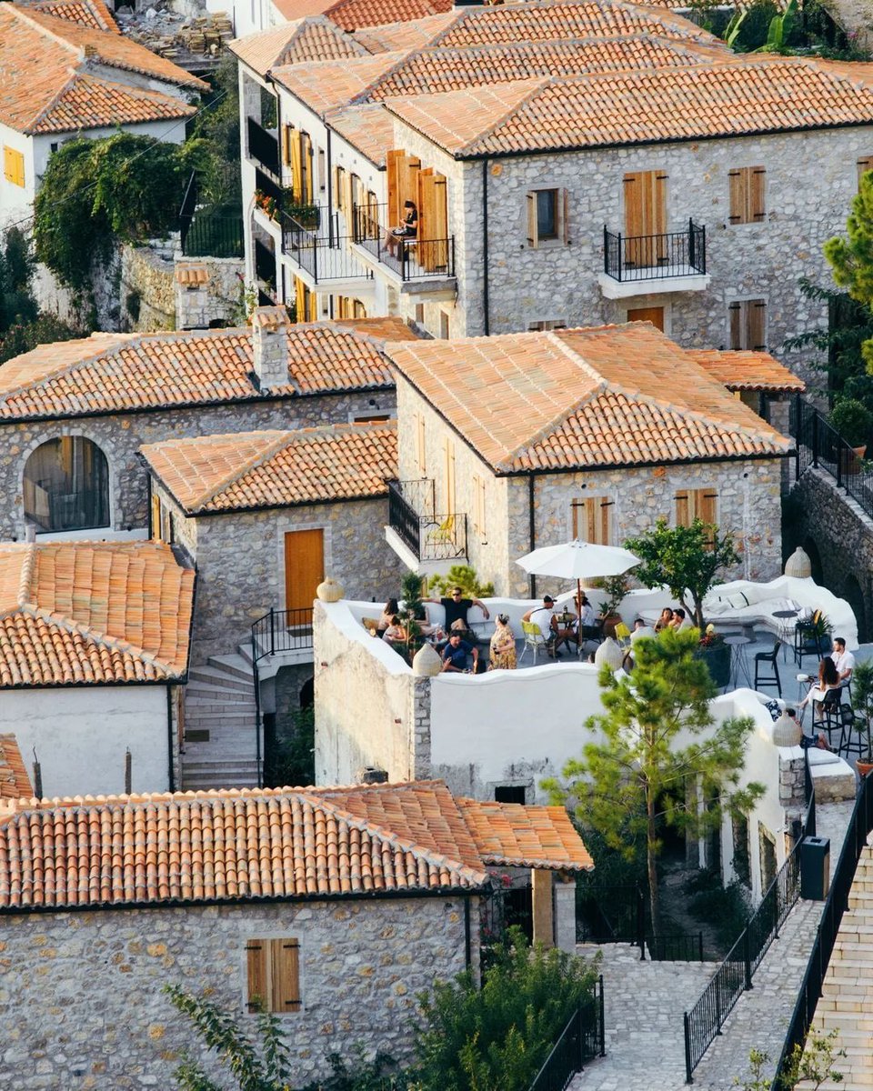 shavnyuy's tweet photo. Walk through Lisbon, Barcelona, Rome or any great Mediterranean city and the roofs tell you something immediately. They are terracotta. They are clay. And most of them have been sitting there for over a hundred years without being replaced.

Walk through most of our cities and the roofs tell a different story. Aluminum sheets weighted down with stones so the wind does not carry them away. Black roofing absorbing every degree of tropical heat. Roofs that leak every rainy season and lift off every harmattan, then get patched, then leak again, then get replaced, then leak again.

When this argument comes up, the response is always the same: clay is too heavy. This from people who spend every dry season watching their aluminum sheets fly off and every wet season putting buckets under the holes. The roof that requires stones to stay on the building is apparently lighter than the one that has been sitting on buildings in southern Europe for a century without moving.

Clay tiles last between 50 and 100 years when properly installed. They are fire resistant, rot resistant and their natural thermal properties keep interiors cooler without electricity in the exact climate we live in. Africa has the clay, the soil and the kiln tradition to produce them locally. What we are missing is the willingness to think past the next rainy season when we build.

The aluminum sheet is not affordable. It is cheap today and expensive for the rest of your life.