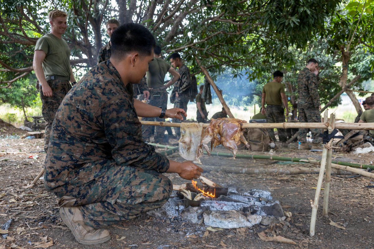 IIIMEF's tweet photo. Marines with 3rd Marine Division prepare and cook chicken over a fire during a jungle survival class at Fort Magsaysay, Nueva Ecija, Philippines, May 30, 2026. @3d_Marine_Div https://t.co/Zb89pi3Ta6