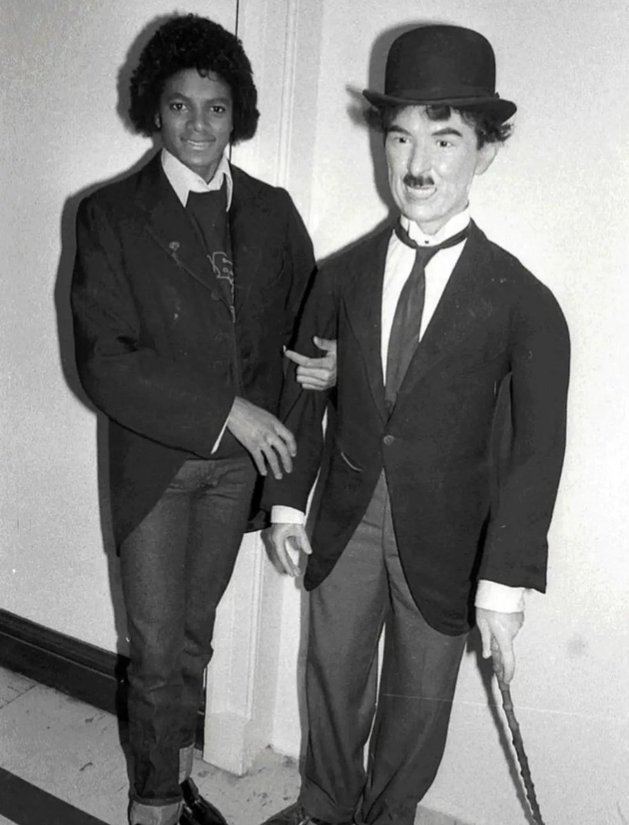 toughboi9_'s tweet photo. Michael Jackson as Charlie Chaplin - A Rare Tribute (1979)

In 1979, during a trip to London, 21-year-old Michael Jackson paid a heartfelt homage to his lifelong idol - the legendary Charlie Chaplin.

Photographed by Tony Prime, Michael dressed as "The Little Tramp" (Chaplin's iconic character) complete with bowler hat, cane, baggy trousers, and moustache. The photoshoot took place on East Street in South London - the very streets where Chaplin once lived with his family.

Michael deeply admired Chaplin and often called him one of his biggest inspirations. He loved how Chaplin could make the entire world laugh and cry through silent performances, brilliant physical comedy, and powerful emotional storytelling.
From Chaplin, Michael learned valuable lessons about timing, movement, dance, and connecting with audiences on a deep level.

Later, Michael paid tribute by covering the song "Smile" (originally composed by Chaplin for his movie Modern Times) on his HiStory album.
Michael once said about Chaplin:
"This is in memory of a great man who has touched the hearts of the world with his art of making people laugh and cry."

These rare photos capture not just a costume, but the deep respect from one genius to another - The King of Pop honoring the King of Silent Cinema