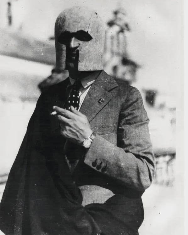 pastarchive's tweet photo. A 1938 photo of Spanish archaeologist Manuel Esteve Guerrero wearing the 7th–6th century BC bronze Greek Corinthian helmet he discovered near Jerez, Spain. https://t.co/XyGmk762hz