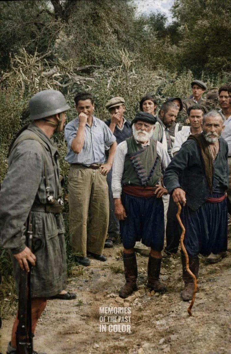 VoicesofWW2's tweet photo. The photo was taken on June 2, 1941 by Franz-Peter Weixler, a war correspondent for the German army. It shows German paratroopers (Fallschirmjäger) escorting Greek civilians from the village of Kondomari to their execution site. The Kondomari massacre occurred on June 2, 1941, in the village of Kondomari, shortly after the German invasion of Crete during World War II. Following the heavy losses suffered by German paratroopers in the Battle of Crete, occupation forces carried out reprisals against civilians suspected of aiding Allied forces and resisting the invasion. On the orders of General Kurt Student, soldiers murdered at least 23 male civilians from the village; some estimates suggest the number may have been higher (up to 60). The victims were unarmed and included elderly men.