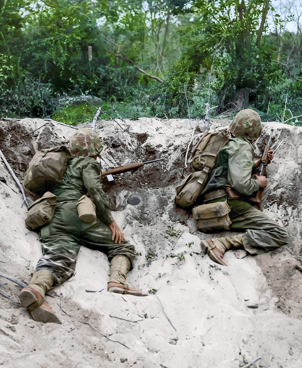 DevilDogGraphix's tweet photo. In this colorized photograph, two U.S. Marines are preparing to move out of a shell crater and advance towards Japanese positions, on the island of Saipan in June 1944. 

#USMC #WWII #Saipan #Military #History https://t.co/MfoE2rUTXE