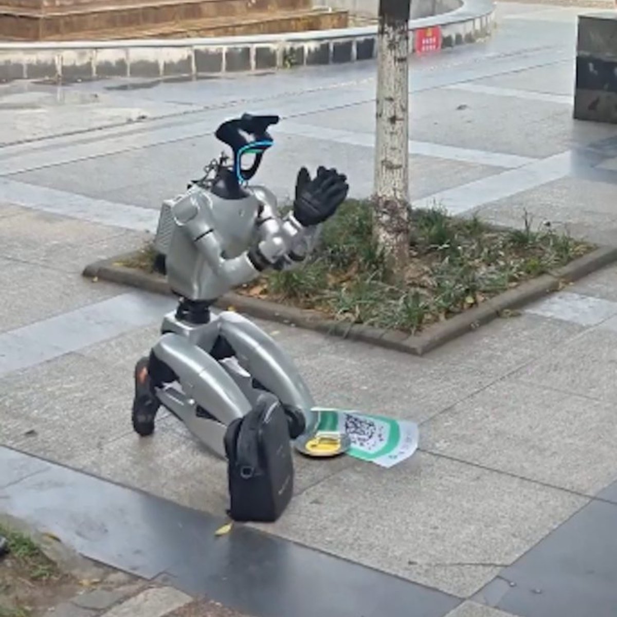 Dexerto's tweet photo. Humanoid robots have been spotted begging on the streets of China with signs asking people to pay their electricity bills

The robots display QR codes for donations and have appeared in multiple cities https://t.co/X7kM6IgG8m