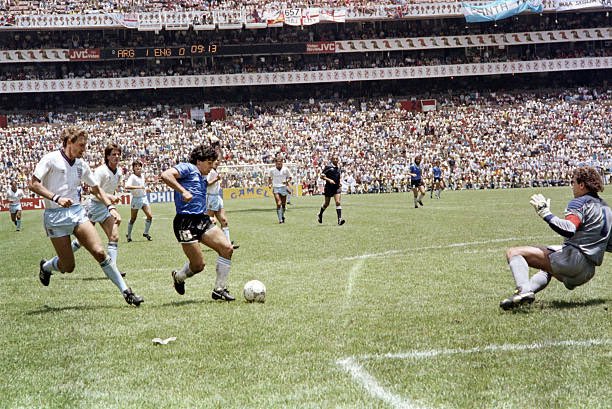 _HucumPress's tweet photo. 🔙 40 yıl önce bugün, 1986 Dünya Kupası çeyrek finalinde Maradona İngiltere’ye karşı tarihe geçen 2 gol attı.

 Önce Shilton’la yükseldiği topu eliyle ağlara gönderdi ve Tanrı’nın Eli dedi. 

4 dakika sonra 5 oyuncu ve kaleciyi geçip “Yüzyılın Golü”nü attı. 🇦🇷👑 https://t.co/z9LERkRFmj