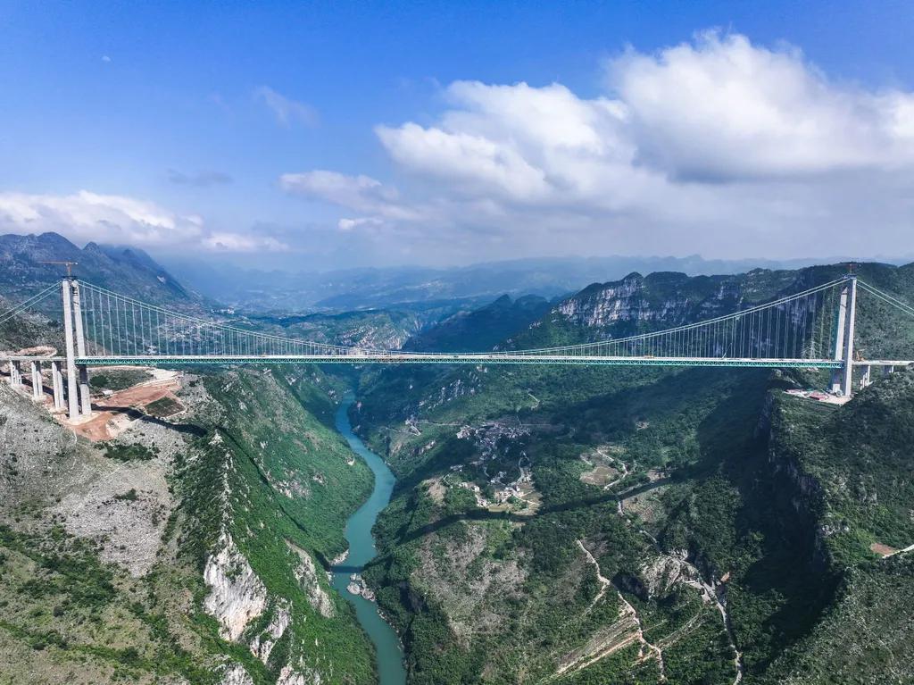 UNlVERSALSTATS's tweet photo. The Huajiang Canyon Bridge in China is an extraordinary engineering project that spans the dramatic Huajiang Grand Canyon in Guizhou Province. Standing about 625 meters (2,051 feet) above the river below, it is recognized as the highest bridge in the world, surpassing many famous skyscrapers in height when measured from the canyon floor.

One of its most striking features is the water drainage system. During periods of heavy rain, water flows off the bridge deck and cascades into the canyon below, creating spectacular waterfall-like streams that appear to pour directly from the sky. These temporary waterfalls can form a massive curtain of water, adding to the bridge's already breathtaking appearance.

The bridge was designed to dramatically reduce travel times across the rugged mountainous terrain of southwest China. Before modern bridges and highways, crossing these deep canyons could take hours. Today, journeys that once required long detours can be completed in just minutes.

Beyond its transportation value, the bridge has become a symbol of China's expertise in large-scale infrastructure and extreme engineering. Suspended high above one of the country's deepest canyons, it offers stunning views of steep cliffs, dense vegetation, and winding rivers far below, making it a remarkable landmark as well as a vital transportation link.