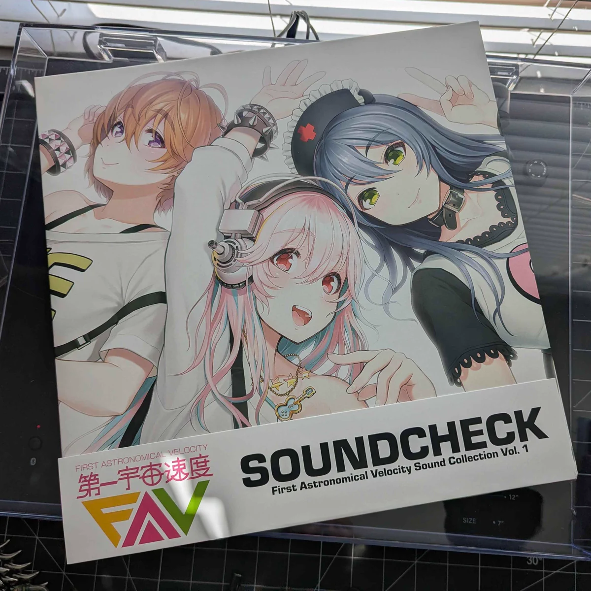 the cover of the vinyl. it features illustrations of (from left to right) watanuki fuuri, super sonico, and fujimi suzu on a white background.