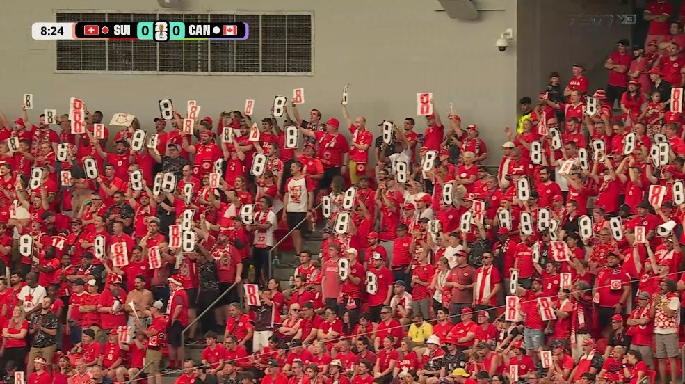 OmerOsman200's tweet photo. The Canadian fans in the crowd put up #8 signs up at the 8' mark, in honour of Ismaël Koné, after the devastating injury he suffered last game vs Qatar.

InShaaAllah speedy recovery for Isma. ❤️🤲 https://t.co/pdZ2pBF9w4