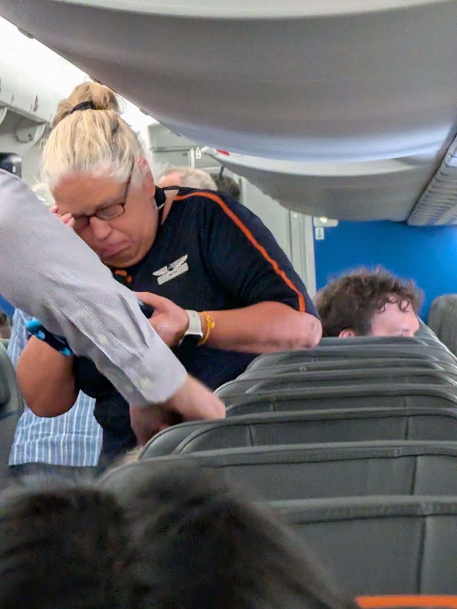Injustices4All's tweet photo. @JetBlue 
I am Mosaic why is she giving me a hard time and why can I not put my travel bag on top of my carry on bag?! https://t.co/lBeF7f2qsh