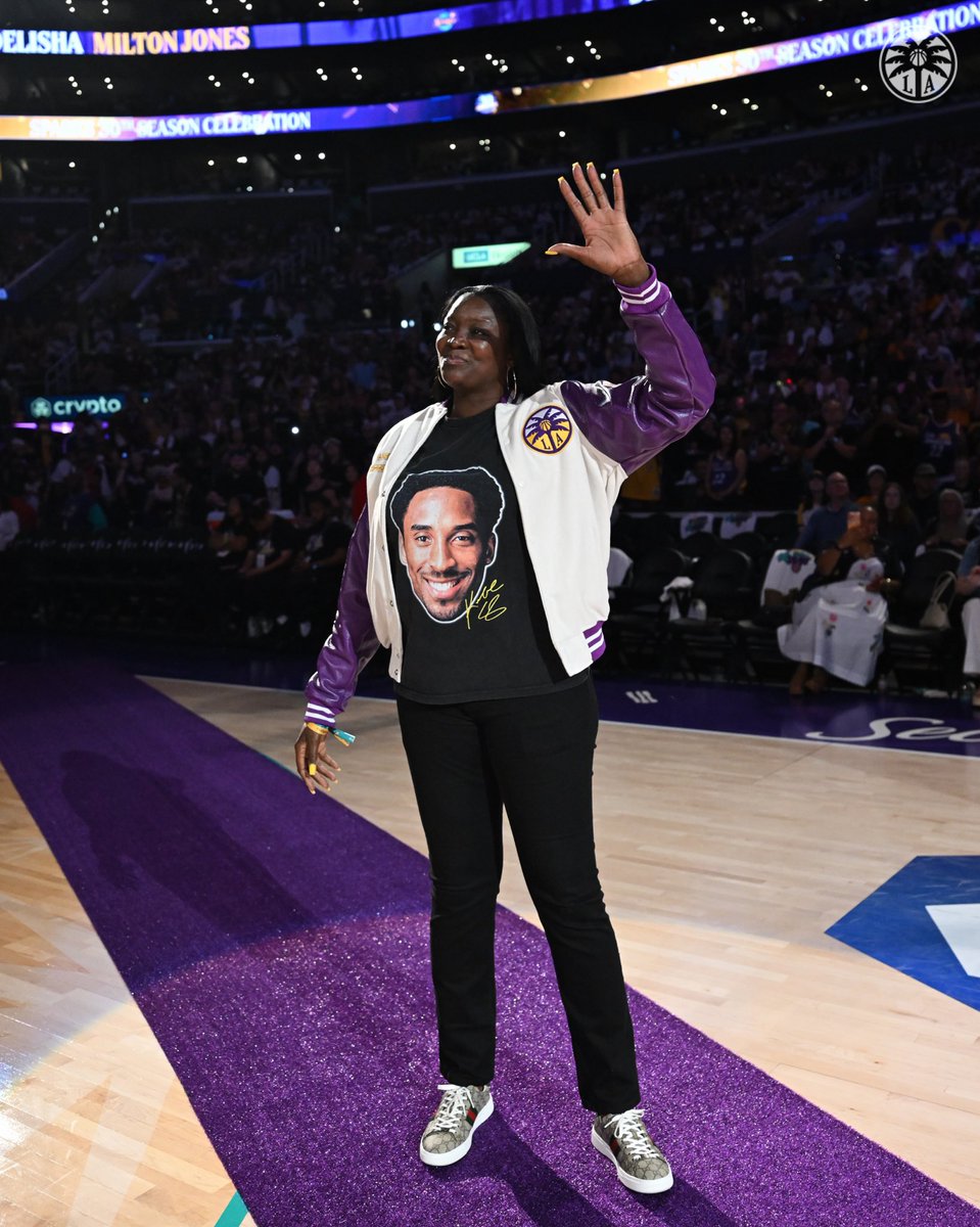 DeLisha Milton Jones waving to the crowd during the halftime ceremony