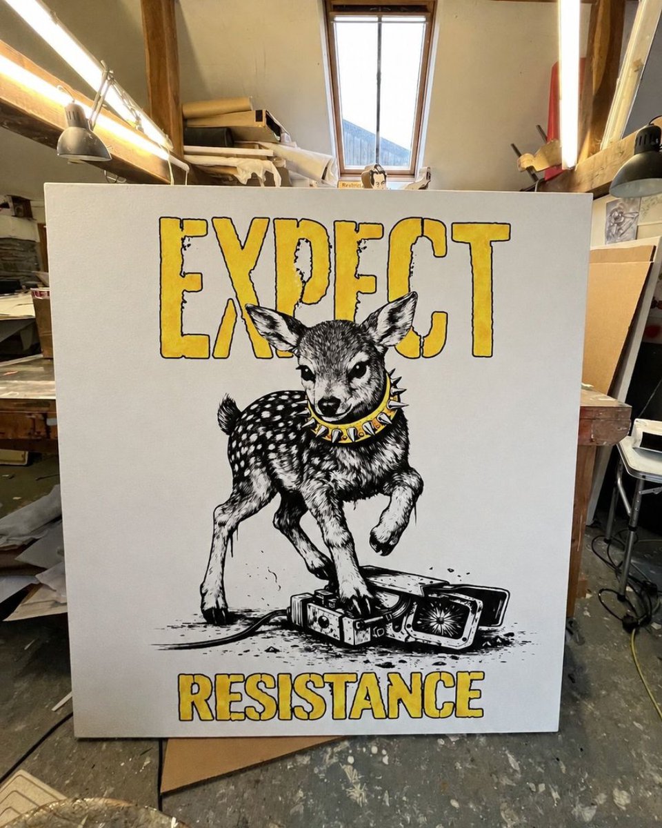 The expect resistance design on a canvas in an art workshop