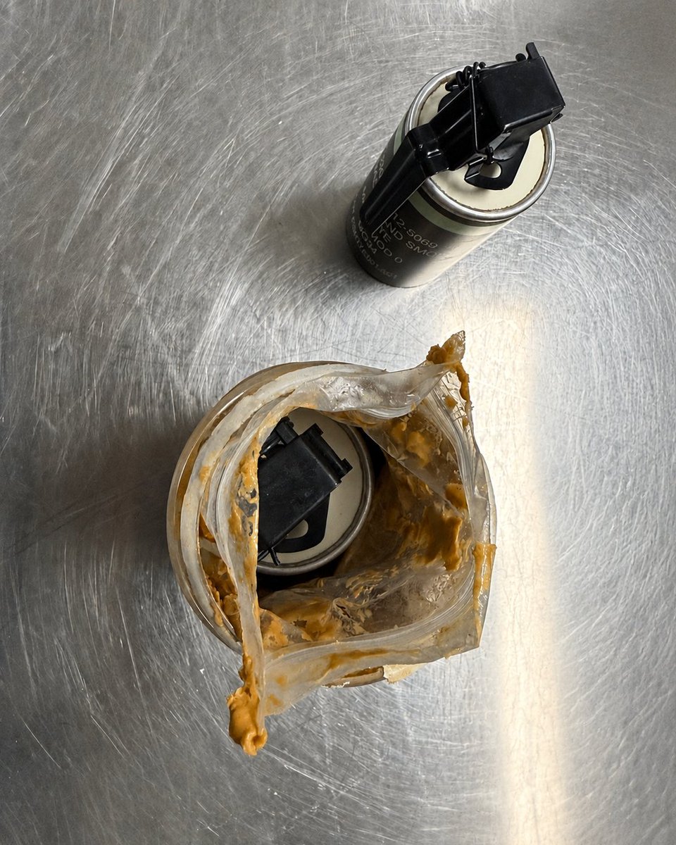 TSA's tweet photo. Last week a traveler flying through Indianapolis International Airport attempted to take two live smoke grenades, one of which was concealed inside of a jar of peanut butter. TSA quickly detected and removed the smoke grenades from the traveler's checked bag. https://t.co/3EwHEzpqgX