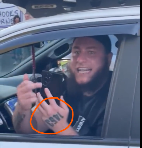 SlimWiggy's tweet photo. This Muslim man was recorded harassing Christians in Australia. Note his tattoo. 1453, the year Muslims conquered Constantinople and brought a violent end to the Eastern Roman Empire. 

Please stop telling me people just "want a better life" or to mind my own business, if you mind their business the message is loud and clear.