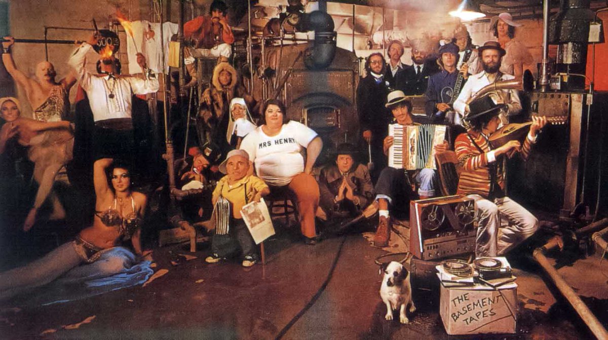 TheBandOfficial's tweet photo. 51 years ago today, Bob Dylan and The Band released The Basement Tapes.

The music was famously recorded in the basement of Big Pink in West Saugerties, New York. The cover looks like it was shot there too, but it was actually staged in the boiler room of the Hollywood YMCA. Photographer Reid Miles packed the room with a crowd of characters pulled straight from the songs.

Which characters do you recognize from the lyrics?