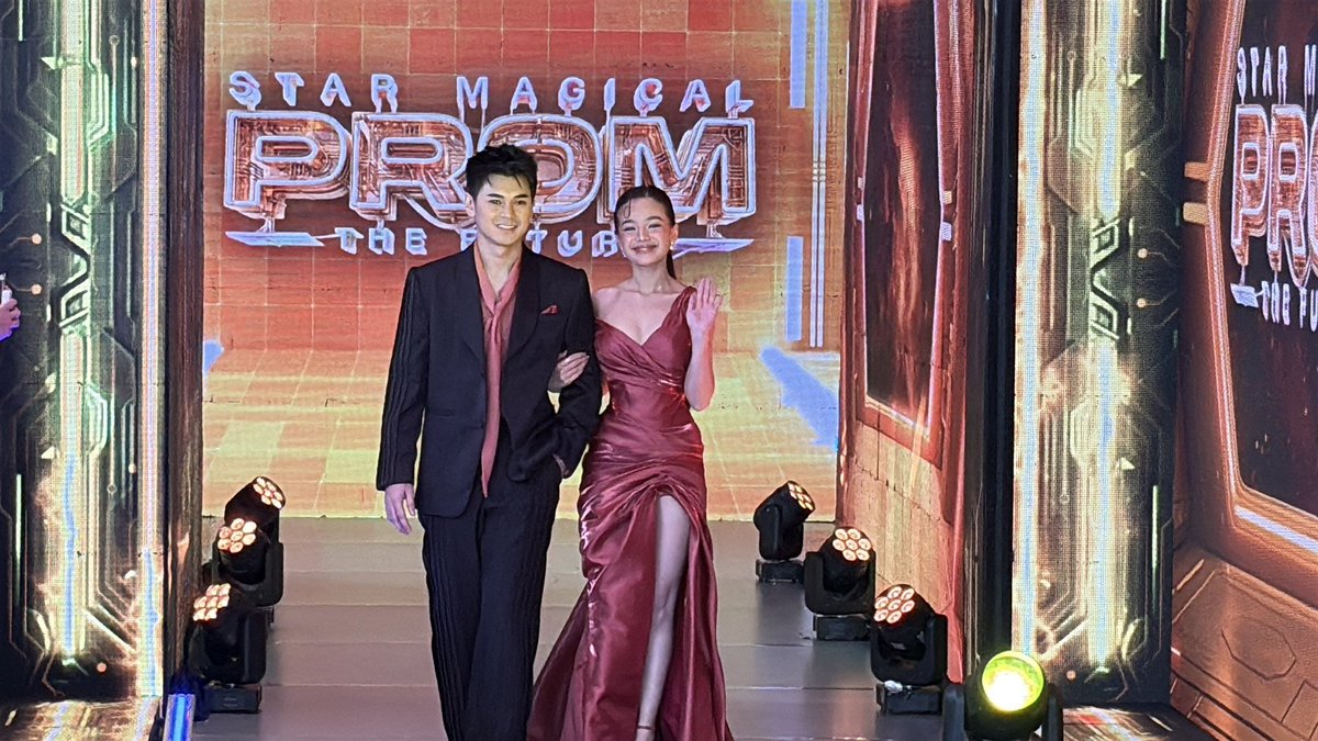 ABSCBNNews's tweet photo. @albertlirio Bianca De Vera and Dustin Yu, more known as "DusBia," walk together in the #StarMagicalProm2026 infinity runway in black and red fashion. #StarMagicalPromTheFuture (📷: @albertlirio) https://t.co/LzuPFhtDnN