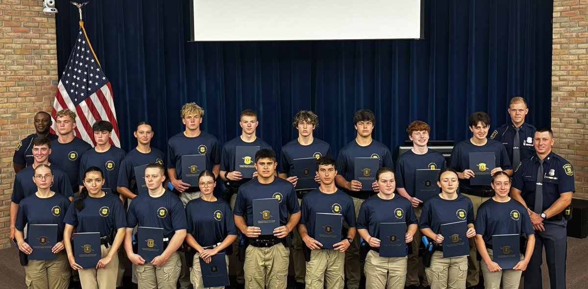 Student troopers with staff at graduation.