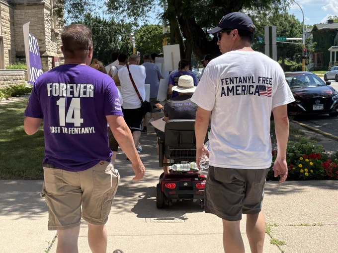 SAC Gillespie, right, walks and talks with a man in a purple shirt that reads, "Forever 14."