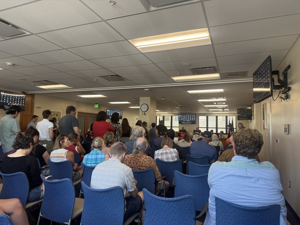 Griffen8Smith's tweet photo. Happening now: The Board of Missoula County Commissioners are considering a one year moratorium to new data centers in the county. More than 100 people are in attendance for the meeting, and many are standing in lines to give public comment https://t.co/OIuUwa59BN