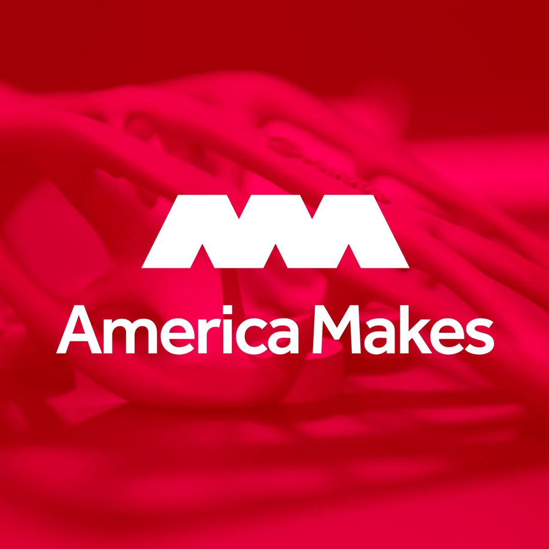 Red-toned image with the logo and text "America Makes" prominently displayed. Abstract shapes form the background.