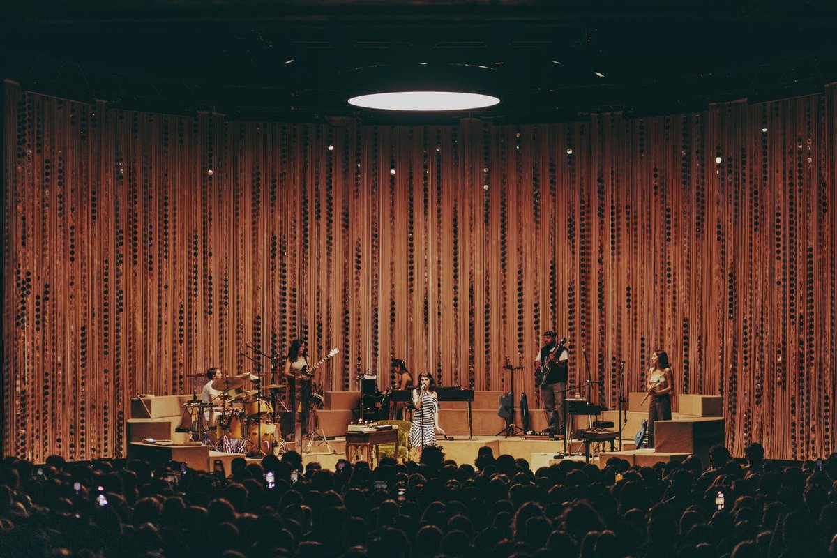 PigsAndPlans's tweet photo. Third time's the charm, as they say, and for Clairo's third album, the 1970's-inspired stage design captivated audiences around the world.⁠
⁠
The conversation pit layout of the band is a mesh between a luxe late-night TV set and a midcentury living room, equipped with carpet and mood lighting to fulfill the fantasy. He explained that "at every show, they have music that plays, and [Clairo] and the band come out, they have a drink together on stage, and I think the whole show kind of has that vibe. It's built around the idea that we wanted them to feel comfortable on stage and in their environment."⁠
⁠
Clairo's third album 'Charm' was released two years ago today.⁠