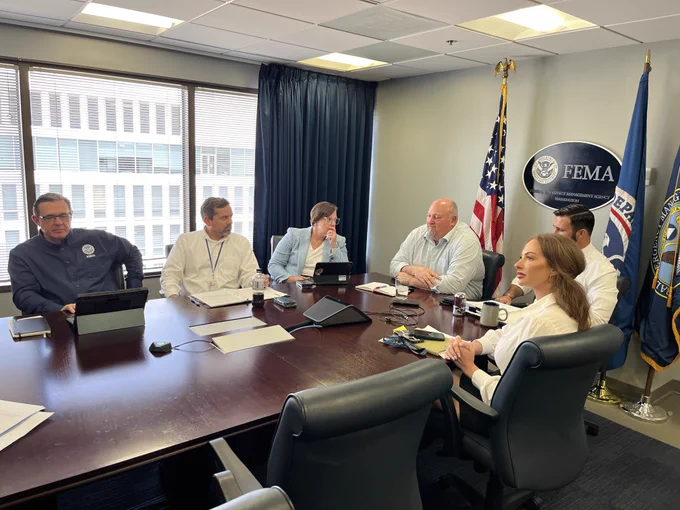 FEMA senior officials meeting in a conference room.