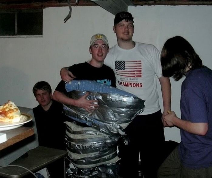 thegoldenaged's tweet photo. The iconic “gamer duct-taped to ceiling” during a LAN party in Michigan (2003) https://t.co/waby2lILE4