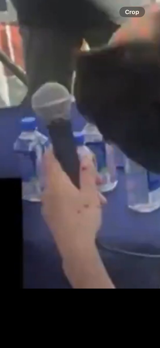 realjakebush's tweet photo. If Charlie Kirk was shot with a bullet, how did he get wounds on his hands seconds after he gets hit? Almost like microphone shrapnel hit his hand and maybe his ring. 

Photo from Erika’s video and the behind Charlie footage. Those are shrapnel wounds. @RealCandaceO https://t.co/keiAQ2GibW