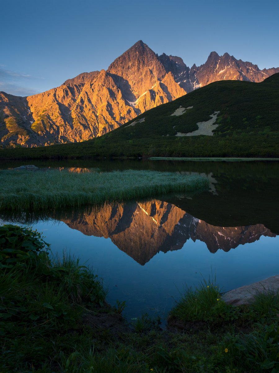 Hasselblad's tweet photo. Morning light paints the mountains in warm tones while crystal-clear water reflects every peak with quiet precision.  

Across the foreground, alpine flowers introduce subtle colour and texture to the expansive scene.  With 100MP medium format and Hasselblad Natural Colour Solution, every shade of rock, sky, and wildflower is rendered with exceptional fidelity.  

📷 filiphrebenda 
📸 X2D II 100C, XCD 35–100E  

#Hasselblad #X2DII100C #100MP #HNCS #LandscapePhotography #NaturePhotography