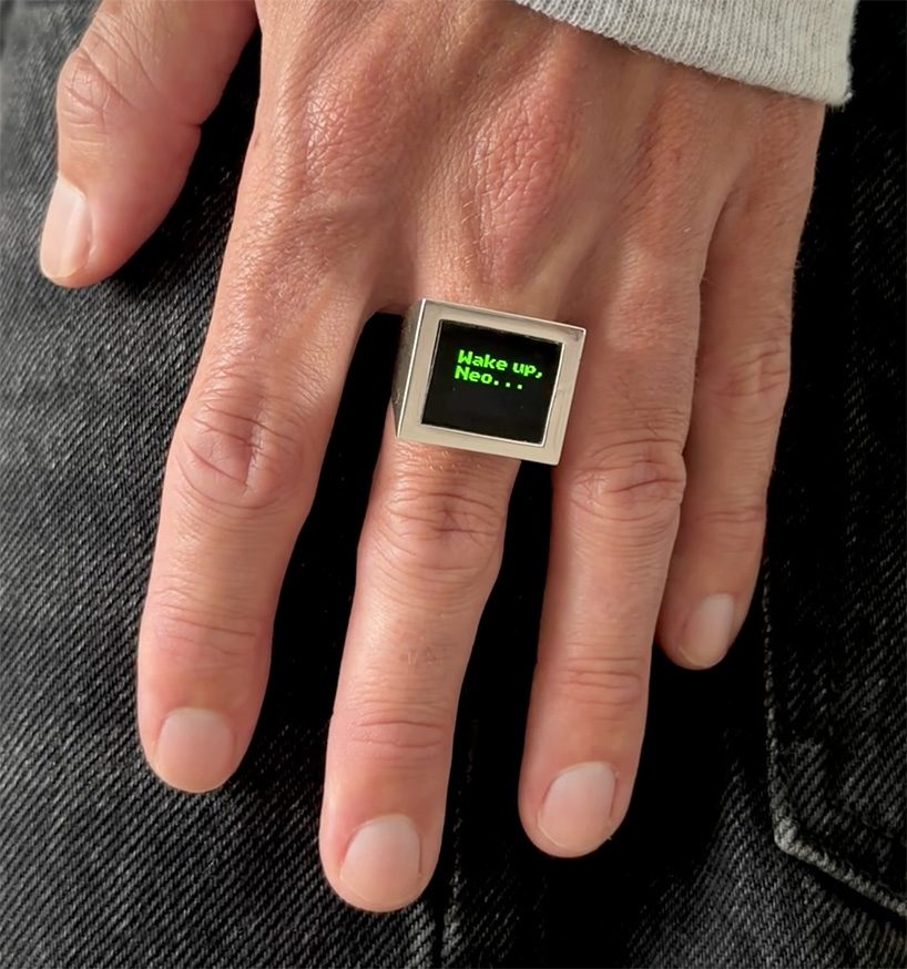 designboom's tweet photo. miniature OLED display loops the matrix's cascading green code inside a signet #ring https://t.co/mnxrCztsCK https://t.co/gfRlPWB4mG