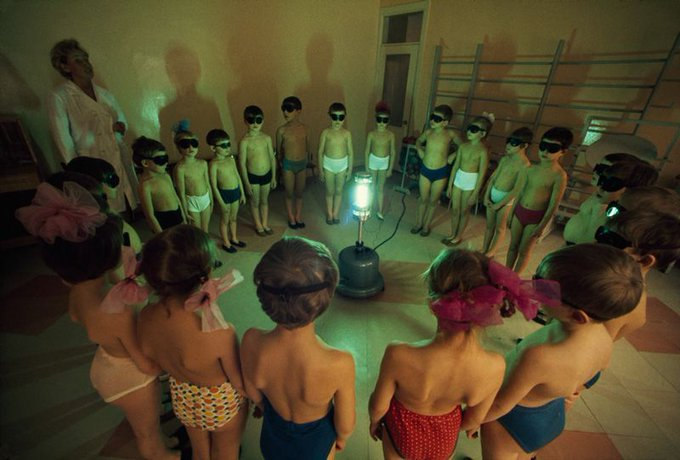 eastblocvisuals's tweet photo. Children circle around an ultraviolet lamp to get a dose of vitamin D, Murmansk, USSR, 1977. https://t.co/xfRdIM9Vkw