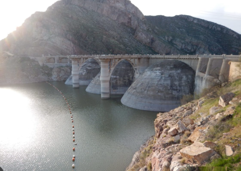 ASCENDING_AZ's tweet photo. ONE OF ARIZONA'S LARGEST RESERVOIRS JUST DROPPED FROM 60% FULL TO LESS THAN 1% -- AND IT WASN'T EVEN THE COLORADO RIVER.

NASA Earth Observatory released satellite imagery this month showing just how far San Carlos Reservoir has collapsed. Formed by Coolidge Dam on the Gila River in southeastern Arizona, the reservoir ranks among the state's largest bodies of water when full, at a capacity of roughly 900,000 acre-feet. A Landsat 9 image captured May 22, 2026 shows it holding just 389 acre-feet of water -- about 127 million gallons, less than 1% of capacity. A comparison image from June 2023 shows the same reservoir at roughly 60% full. Same lens, same angle, almost unrecognizable.

The cause traces back to a historically bad snow year. The Gila River watershed, fed by snowmelt off the Mogollon Mountains and Black Range in southwestern New Mexico, saw mountain snowpack fall to just 2% of the 1991-2020 March median this past winter -- one of the worst snow seasons on record for the region. With that little snow to melt, April streamflow into the reservoir reached only 39% of normal. Mandatory water releases for downstream agriculture under the San Carlos Irrigation Project, tied to the dam's original 1924-1928 construction purpose, further drained what little remained.

The ecological consequence was severe. As the reservoir shrank, the shallow water left behind heated rapidly under the Arizona sun, and warm water holds far less dissolved oxygen than cold water. The result was hypoxia -- a fatal drop in oxygen levels -- that killed virtually the entire fish population, including largemouth bass, black crappie, bluegill, channel and flathead catfish, and stocked brown and rainbow trout. The San Carlos Recreation and Wildlife Department closed the reservoir indefinitely on June 5, 2026, citing what officials described as a catastrophic, complete fish kill, and warned that decomposing fish could pose health hazards to anyone attempting to boat or fish there in the meantime.

Rhett Larson, a water law professor at Arizona State University, put the severity in blunt terms to 12News: "This past winter was the worst we'd ever seen."

This isn't unprecedented for San Carlos specifically -- the reservoir has run completely dry at least 20 times since it first filled in 1930, and fish kills also occurred in 1976-77 (an estimated 5 million fish, requiring a 5-year ecosystem recovery), 2018, and 2022. But the scale and timing of this one land squarely in the middle of a much broader stretch of Arizona water stress. The same winter that starved the Gila River watershed also left the Colorado River's Upper Basin snowpack well below average, with Lake Powell dropping to just 24% full by mid-April and the Bureau of Reclamation warning it could fall below the level needed to generate hydropower by August without intervention. Lake Mead has faced its own operational restrictions. Three major Arizona water systems -- the Gila, the Colorado, and the reservoirs that depend on both -- are all under real strain in the same year, not as three separate stories but as one broader pattern.

Recovery for San Carlos now depends almost entirely on how much rain actually falls this monsoon season. NOAA's outlook issued in May put the odds at 33 to 50 percent for above-average summer rainfall in the region -- real hope, but far from a guarantee. Even with a strong monsoon, wildlife officials say restoring the reservoir's fish population to anything resembling pre-collapse conditions will likely take multiple seasons of recovery, not one good storm.

Water security in this state isn't a single story about one river. It's several stories, in several watersheds, all under pressure in the same year -- and this one just became impossible to ignore from space.

#Arizona #WaterSecurity #GilaRiver #Drought #Sustainability #ColoradoRiver