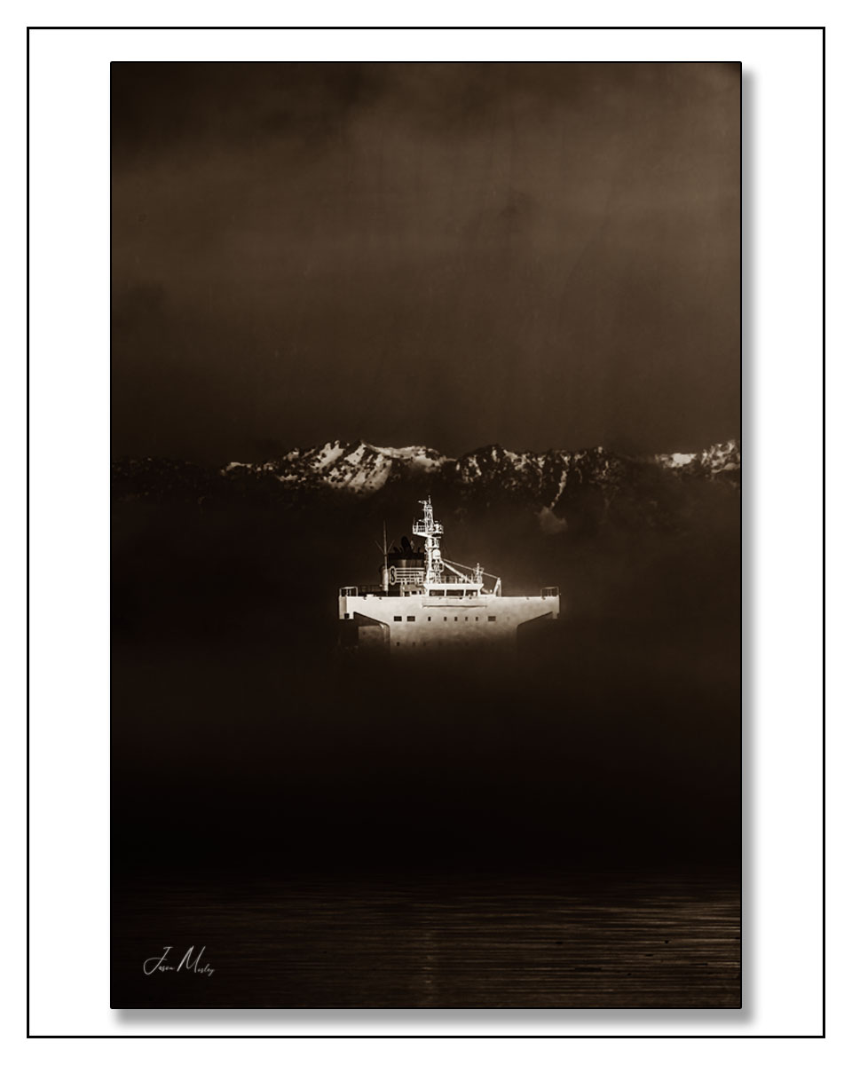 JasonMosleyPho1's tweet photo. A ship materializes through the fog in Elliott Bay — Olympic peaks breaking through the clouds above, dark water below. Sepia was made for a frame like this. https://t.co/mH7mppJ29A