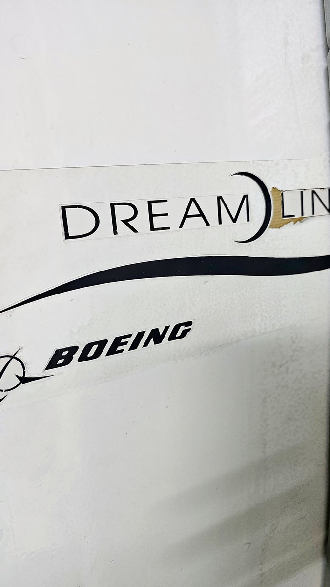 Fahadnaimb's tweet photo. The 787 and A350 are fantastic aircraft.. lighter, stronger, burn less fuel thanks to all the carbon fiber. But painting them properly has been a real headache since day one. Composites just don’t play nice with paint the way old aluminum did. They flex more, expand and contract differently when the temperature swings from a 40°C ramp in the Middle East to -55°C at cruise altitude.

On the 787, UV at altitude breaks down the bond between the primer and the composite resin. The A350 had extra drama with the copper lightning protection layer not moving the same as the skin, which cracked the paint at the joints.

So the topcoat cracks, lifts, and peels exactly like this. Airlines still paint them with full liveries because it looks good and protects the composite underneath. But once it starts failing, the practical fixes are speed tape or a quick white overspray to hide the damage until the next heavy maintenance. And yeah... those silver-taped wings or fuselages go mega viral every single time.

People lose their minds thinking the plane is falling apart. It’s not. It’s a cosmetic, approved temporary repair to keep UV and moisture off the bare composite.
From the maintenance side it’s just extra work and more frequent touch-ups.

Boeing and Airbus have brought in proper fixes for newer aircraft (better UV blockers, more flexible foils), so it should improve over time. But right now this is part of the daily reality on the line.
Honestly, sometimes you miss the old polished metal days… but these composite jets are still the future