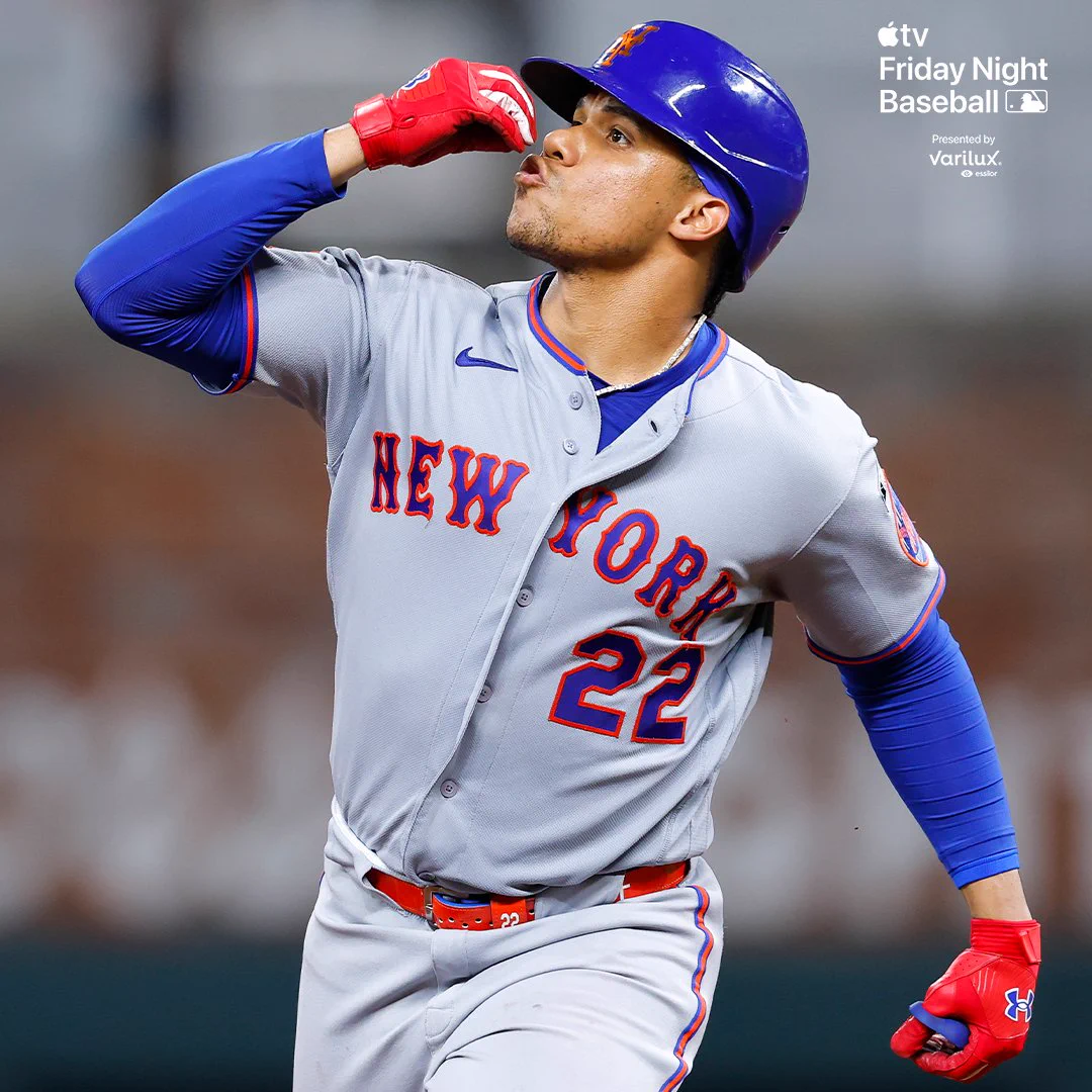 Juan Soto celebrates rounding second base. He is wearing a gray Mets uniform and a blue batting helmet.