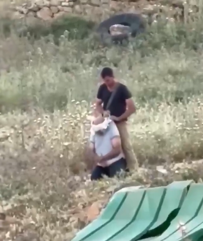 Naila_Ayad's tweet photo. A Palestinian farmer was humiliated and stopped from tending to his land by a settler.

He was then blindfolded and dragged around the floor. Sickening. https://t.co/i1RkwiadSr