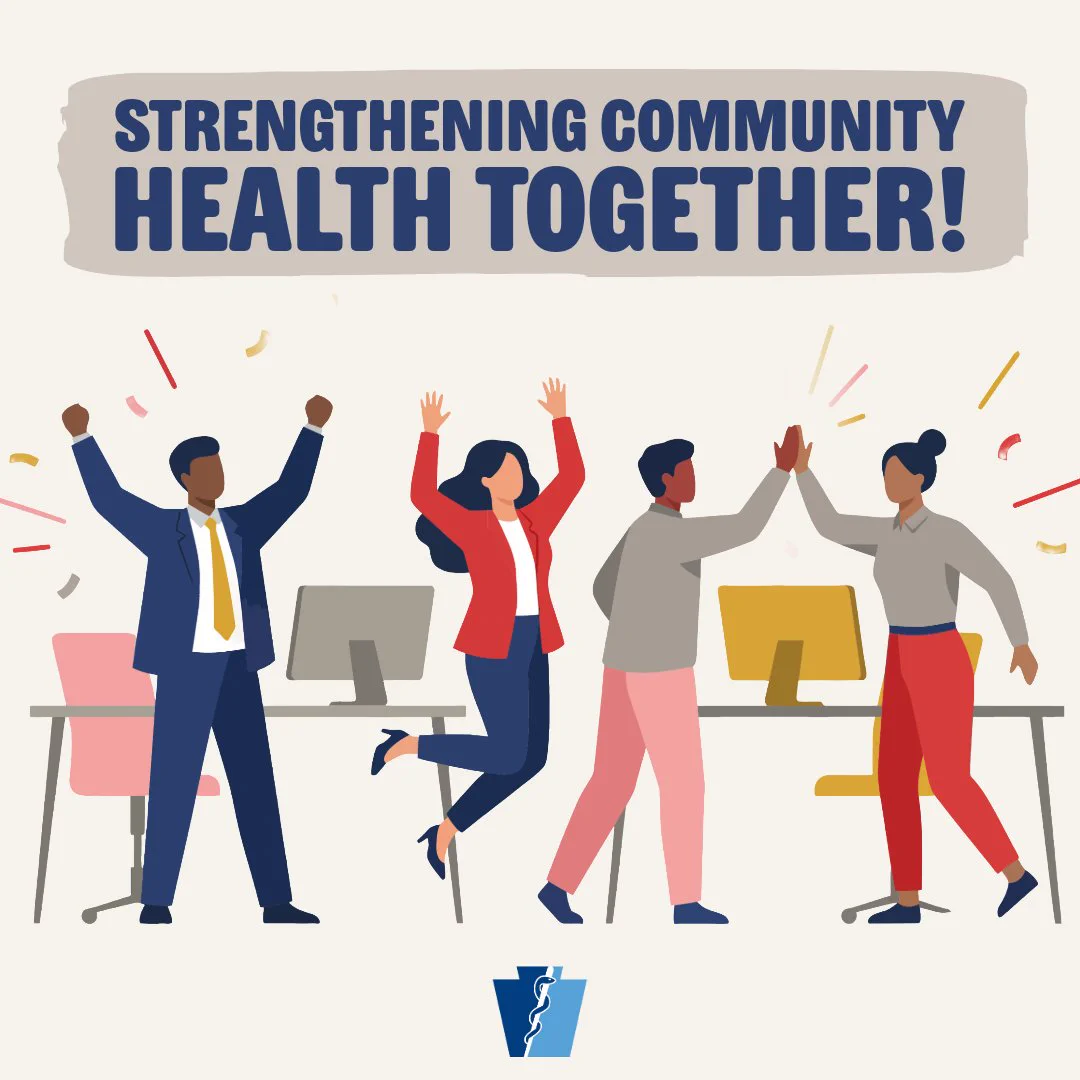 Diverse group of four professionals celebrating success in an office with computers, emphasizing community health collaboration.