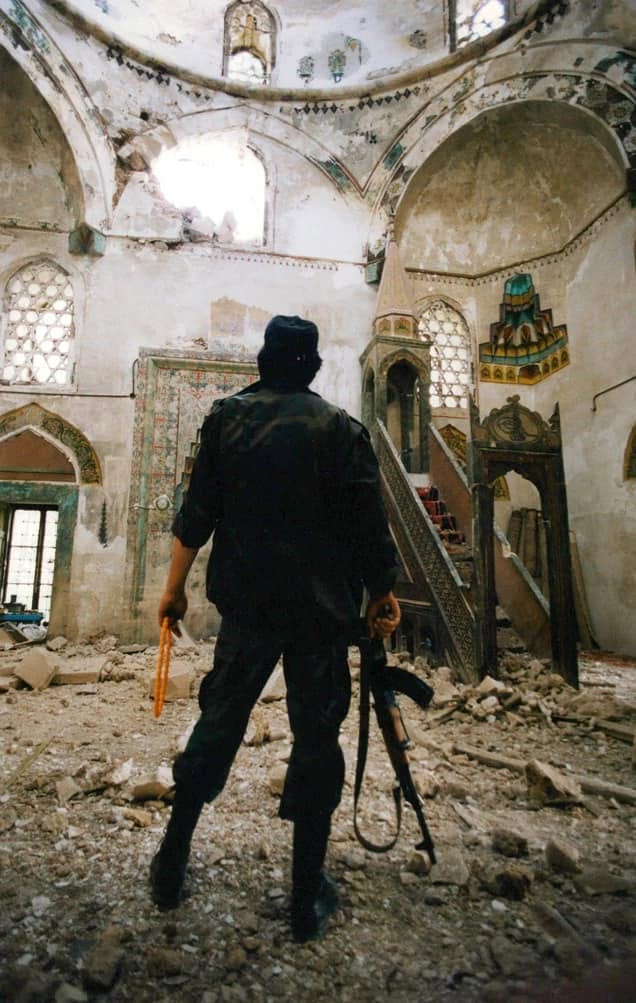 julaibib18's tweet photo. A Bosnian soldier inside the badly damaged Koski Mehmed-Pasha Mosque.

June 1992, Mostar https://t.co/5mPhznvfsO
