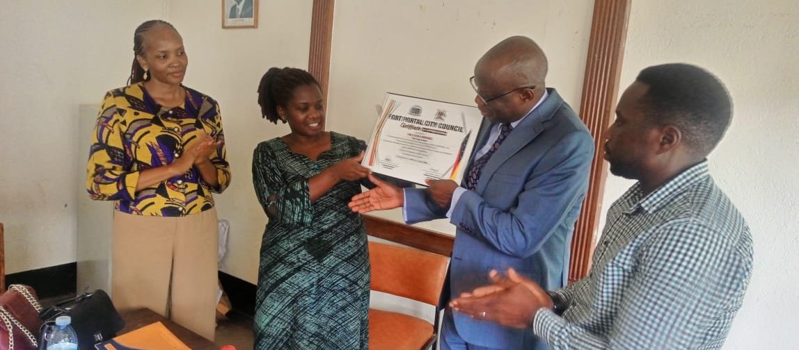 fortportal_city's tweet photo. Outgoing Fort Portal Town Clerk Praised for Resolving Conflict and Doubling Local Revenue.

The outgoing Fort Portal Tourism City Town Clerk, Mr. Ocen Ambrose, has left behind a historical legacy of conflict resolution and financial growth, Deputy Mayor Hon. Margaret Kabajwara has observed. 

Representing the City Mayor at the official handover ceremony to the incoming Town Clerk Madam Akello Regina at the RCC's Boardroom, Hon. Kabajwara revealed that Mr. Ocen assumed office when Fort Portal was battling severe administrative friction. However, through his wisdom and professionalism, he successfully intervened and restored harmony to the city leadership.

The Resident City Commissioner (RCC), Madam Nasike Asumin, noted that while it is disheartening to witness handovers prompted by interdictions, Mr. Ocen’s departure is a celebratory milestone because he is leaving on promotion. 

She highly commended him for his swift administrative actions, particularly in recruiting key human resources. This strategic staffing directly resulted in a massive surge in local revenue, which doubled from 2 billion to 4.1 billion shillings. 

In his final handover report, Mr. Ocen urged his successor, Madam Akello Regina, to prioritize and support staff career growth and development. He also challenged the city technical team to remain focused and deeply committed to improving service delivery for the local population.

Upon receiving the instruments of power, Madam Akello expressed her gratitude to Mr. Ocen for his exemplary leadership, steadfast guidance, and dedication to mentoring staff.
She called for collectiveness ,responsibility and professionalism in execution of duties to build a city to a Model and sustainable enjoyed by everyone.
Mr. Ocen Ambrose joins Muni University as University Secretary.