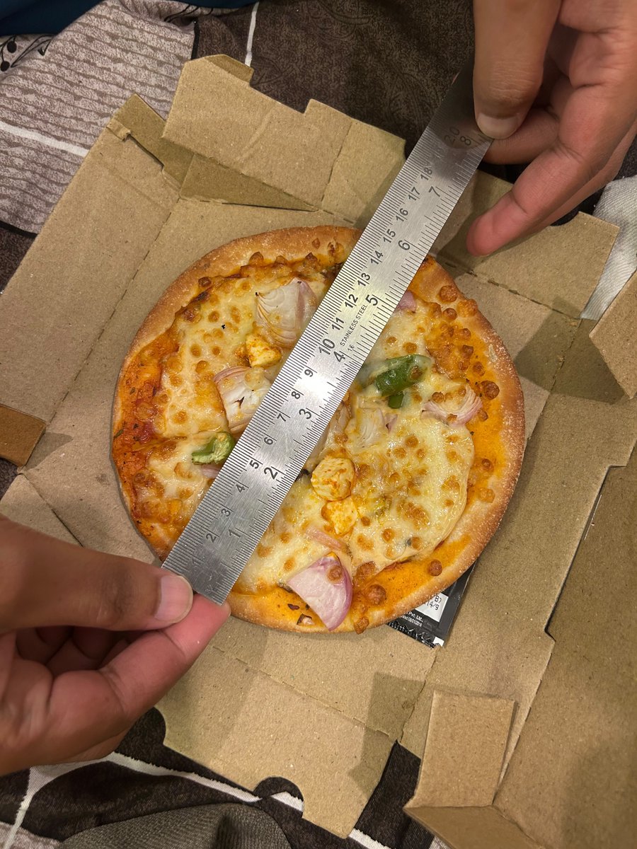 NotVidev's tweet photo. The downfall of @swiggy

1/3

@harshamjty I saw a ₹400 pizza on "Swiggy" for ₹99, advertised as 9 inches.

What showed up? Barely 6.5 inches.

The toppings? 2 tiny paneer cubes, 3 onion pieces, and 2 capsicum pieces. Easily the most disappointing pizza I've ever had. https://t.co/qvEQJA8UKK