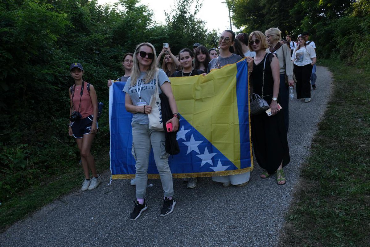 PCRCBiH's tweet photo. This evening, #SYS26 youth led by our founder and president Velma Šarić joined thousands of walkers on the final kilometers of the Peace March. 

This annual three-day trek is retracing the route taken by those who tried to escape Srebrenica in July 1995, walking through the forests of eastern Bosnia toward safety.

For our participants walking alongside survivors, families, and people from across the region wasn't just an act of solidarity: it was a chance to witness remembrance in motion. Along the way, they talked with fellow walkers, listened to their stories, and reflected on what it means to protect memory and work on prevention of atrocities. 

#PCRCBiH #SYS26 #Srebrenica31 #remembrance #youth