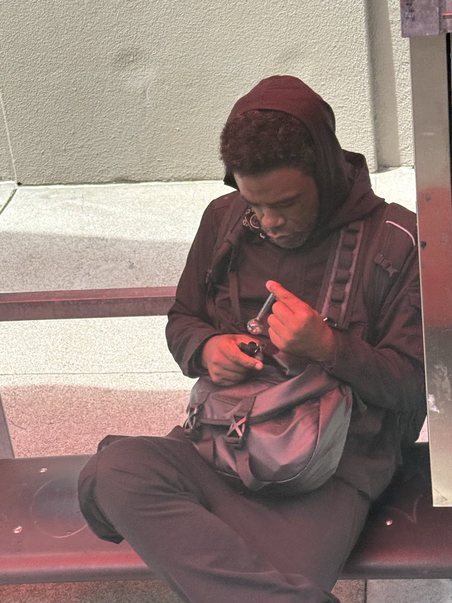 SusanDReynolds's tweet photo. Sacramento and Van Ness at 2:30 p.m. today — drug tourist using bus stop as his personal fentanyl smoking den. Why in the world would anyone want to give more money to SFMTA? https://t.co/9f0MOjZJVU