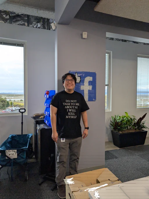 me wearing the DO NOT TALK TO ME ABOUT AI I WILL KILL MYSELF tshirt but in black