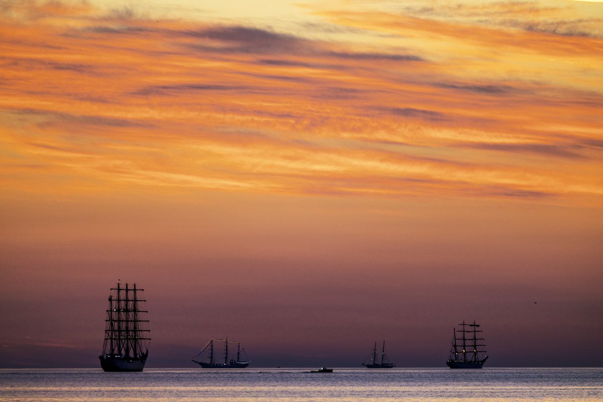 NBC10Boston's tweet photo. A Sail Boston sunrise. Tall ships participating in today’s Sail Boston extravaganza are seen with various stages of this mornings sunrise, starting with a Massachusetts state police helicopter doing a quick scan of the area and then lots of colors. 📸@pictureboston https://t.co/oG9CNonFOf