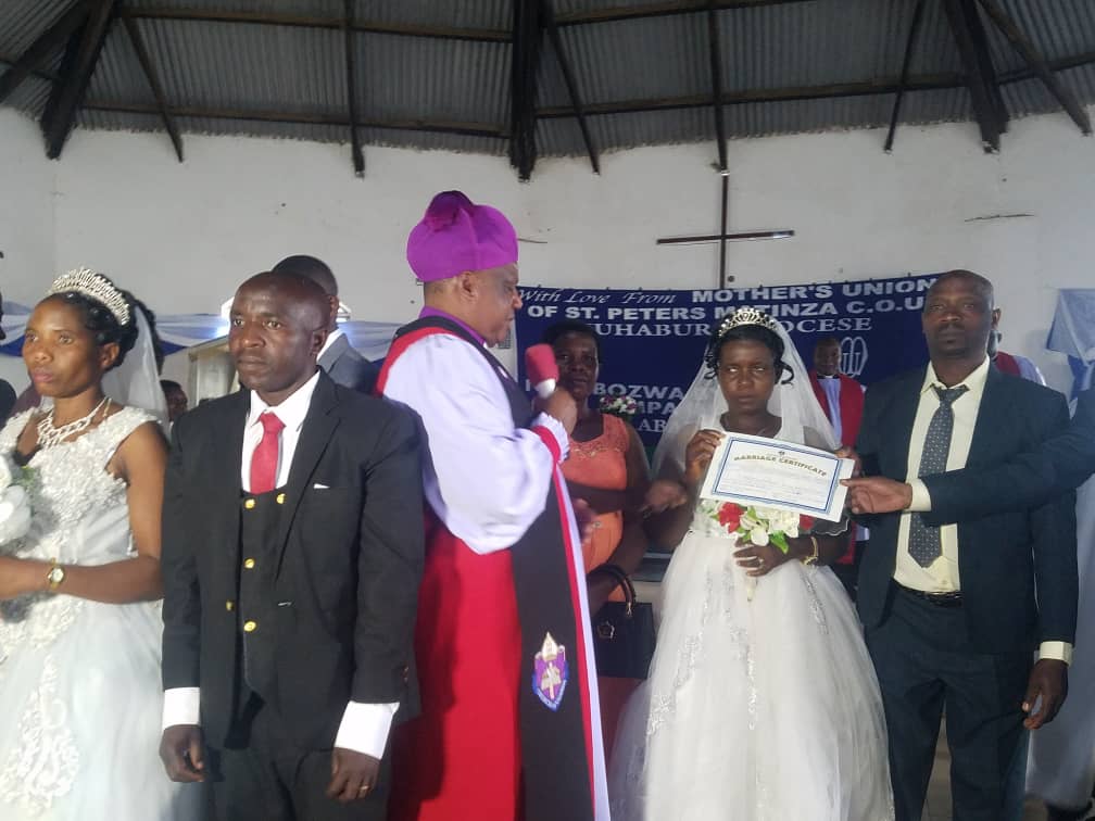 vomuhabura's tweet photo. The Minister of State for Veterans Affairs (Defence), Grace Akifeza Ngabirano, has congratulated seven couples who solemnized their marriages, describing the occasion as an important milestone in their lives.

Minister Akifeza said sponsoring the mass wedding was part of her commitment to encouraging more couples to legalize and solemnize their marriages in church.

She called on married couples to remain united, serve as role models to other families, share responsibilities, and invest in income-generating activities to improve their household livelihoods.

The minister emphasized that stable and strong families play a crucial role in promoting peace, economic development, and moral values within communities.