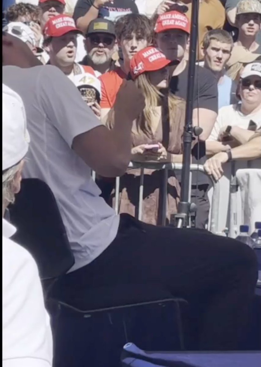 AndySanTH's tweet photo. @jonaaronbray Let's say he had a blood squib tube (besides the yes exploding mic) going up to his neck, wouldn't this look like a tube filled with blood being exposed, rushing up to his neck? Possible? Anyone? Or what else could this black thing be? @jonaaronbray #charliekirk https://t.co/A5LGx0c9sw
