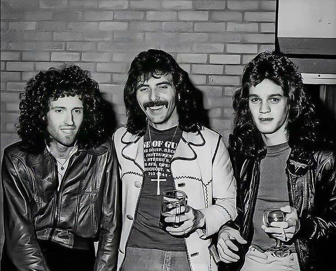 crockpics's tweet photo. Brian May, Tony Iommi, and Eddie Van Halen sharing a drink backstage in London, 1978. Photo by Ross Halfin. 

Van Halen was out on the road opening up for Black Sabbath on their Never Say Die! tour. Night after night, Eddie and Tony forged an incredible bond, staying up until the sunrise talking about guitars. During the UK leg of the tour, Queen's Brian May decided to stop by the show to catch the action, leading to this iconic backstage meetup.