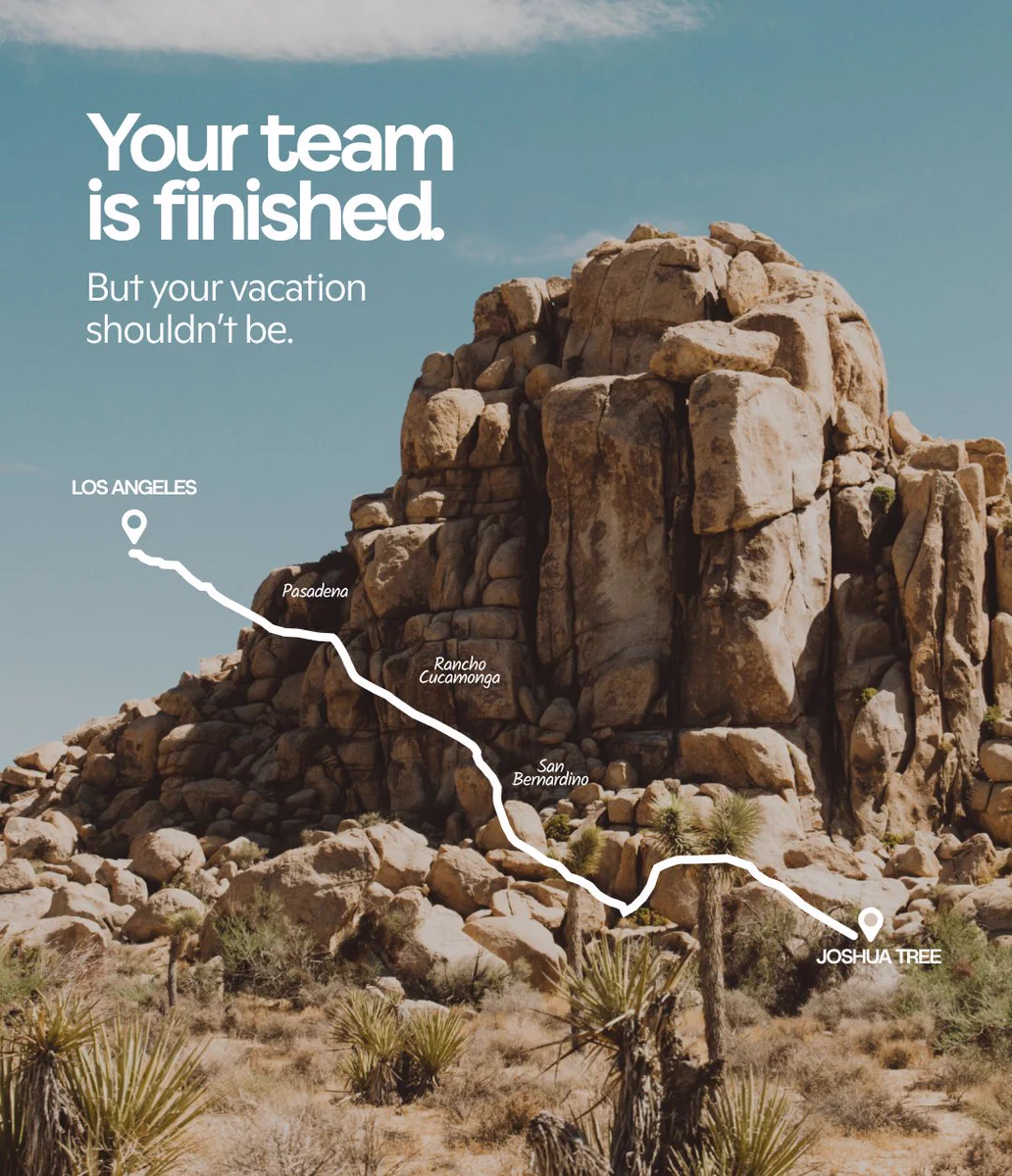 Desert rocks and sparse plants in Joshua Tree with a white route map from Los Angeles overlaid. Text reads: “Your team is finished. But your vacation shouldn’t be.”