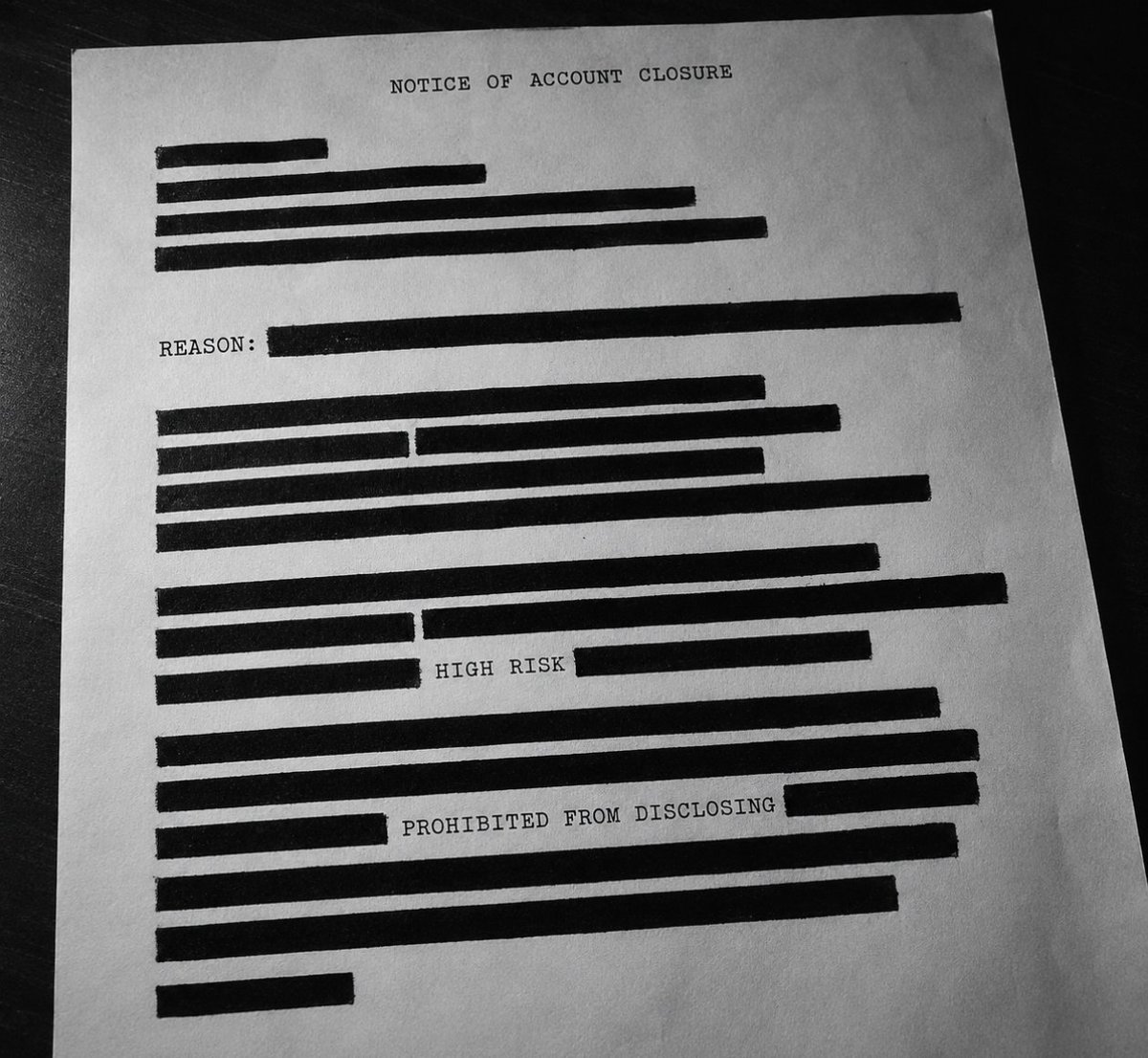 dylanmallman's tweet photo. One morning the card stops working.

You call the bank. The voice is polite and tells you nothing. The account is closed. No, they cannot say why. No, there is no one you can be transferred to who can. 

Your balance will be mailed to you. The relationship is over. That is the entire conversation, and you will replay it trying to find the part where you did something wrong. 

You did not do anything wrong. And the bank that just erased you is forbidden by federal law from telling you what set it off.

This is the half of the surveillance machine nobody argues about. Everyone fights about the watching. Almost no one asks what the watching is wired to. It is wired to a switch that can turn a person off.

Move money in amounts near $10,000 and a clerk files a report on you. Do it a few more times, sometimes as few as just 3, and you are marked high risk inside a system you are not allowed to see. Federal examiners start leaning on your bank, asking why you are still a customer. Your bank runs the numbers. 

Keep you, and risk hundreds of millions in fines if you ever turn out to be guilty of anything. Close you, and risk nothing. Every incentive in the building points at the same door. They walk you through it and lock it behind you.

Losing one bank sounds survivable. But the mark that closed one account follows you to the next. No paycheck that clears. No rent that posts. No card that moves. A person can be removed from the entire economy over a suspicion he is never shown, with no trial behind it and no notice in front of it.

When the government wants a specific target gone, it skips the courts entirely. "Operation Choke Point" pressured regulators to strangle disfavored businesses. The FDIC mailed banks quiet letters telling them to pause all cryptocurrency activity, which everyone receiving them read as a kill order. 

New York pushed every bank and insurer in the state to drop the NRA. When Coinbase sued to drag those letters into daylight, the government handed back pages blacked out so completely that a federal judge called the redactions almost laughable.

Even then, you are told nothing.

Keep cash. Keep gold. Keep Bitcoin. Keep anything they cannot switch off. And understand that the file deciding your access already exists, in an office you will never enter, with your name in it that you are not permitted to read.