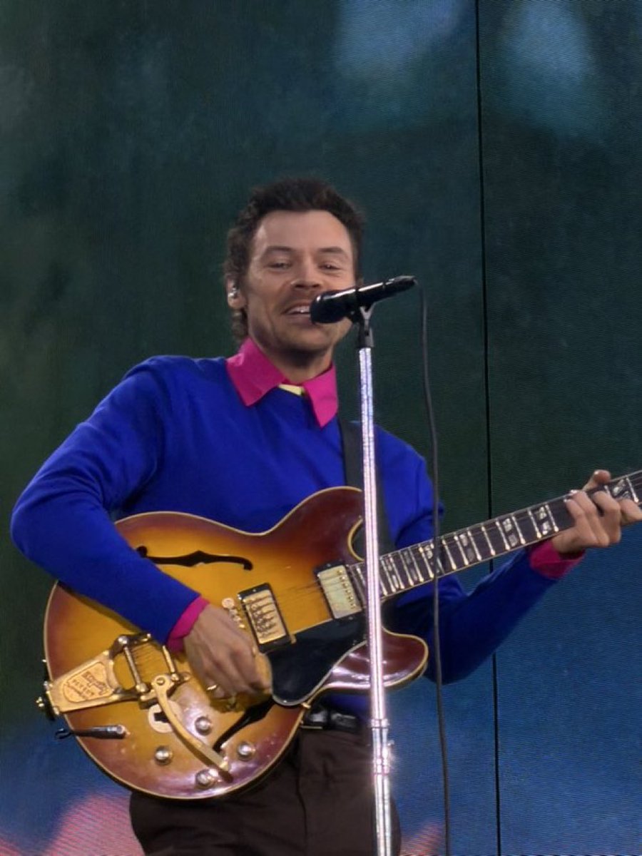 Harry being smiley during Golden on stage at Wembley Stadium in