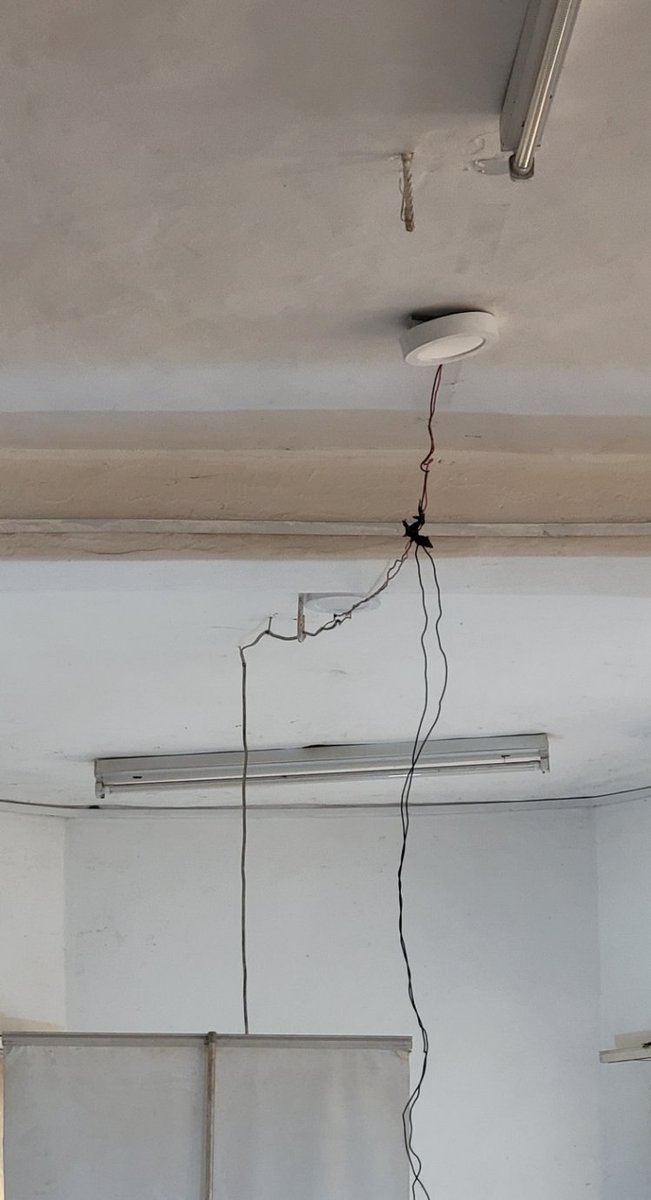 DanielRegha's tweet photo. Before I forget, so this is a NIMC office; So @NigeriaGov you can't buy ordinary ring light for your staff? It's to connect bulbs and have wires swinging left and right? Before someone is done with capture, they will have strained their eyes. What a shame. And take a look at the chairs, how much are new chairs for goodness sake.
